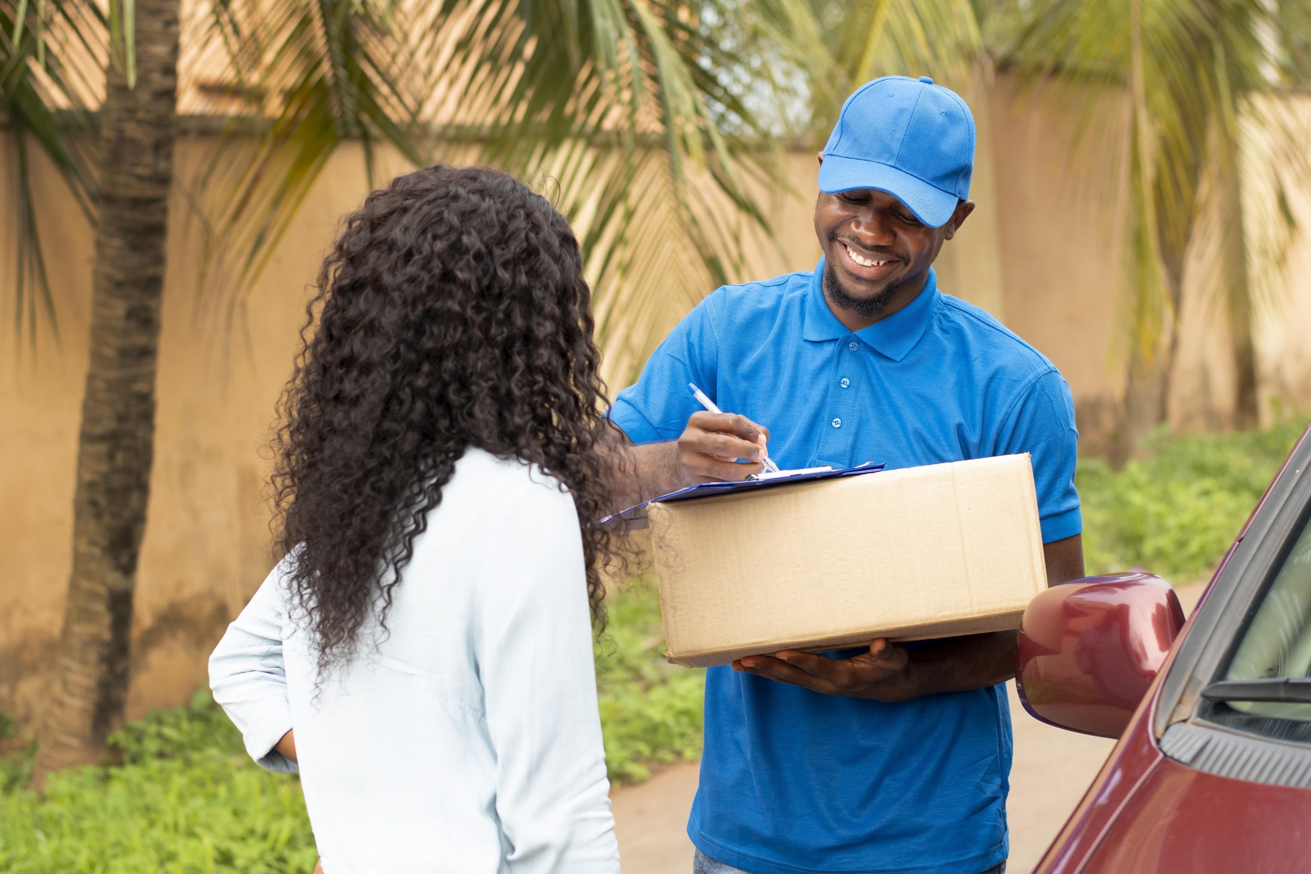 close-up-delivery-person-giving-parcel-client